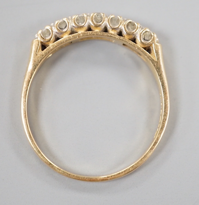 A modern 18ct gold and seven stone diamond set half hoop ring, size T/U, gross weight 3.6 grams.